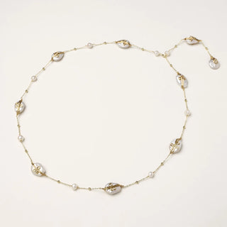 Long gold chain necklace with baroque pearls wrapped in leaf designs and small freshwater pearls spaced along the strand