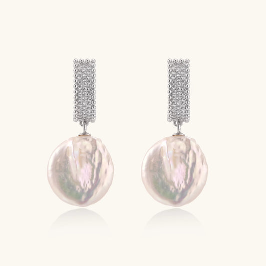 Rhodium-plated silver curved stud with pave stones and baroque pearl drop on white background