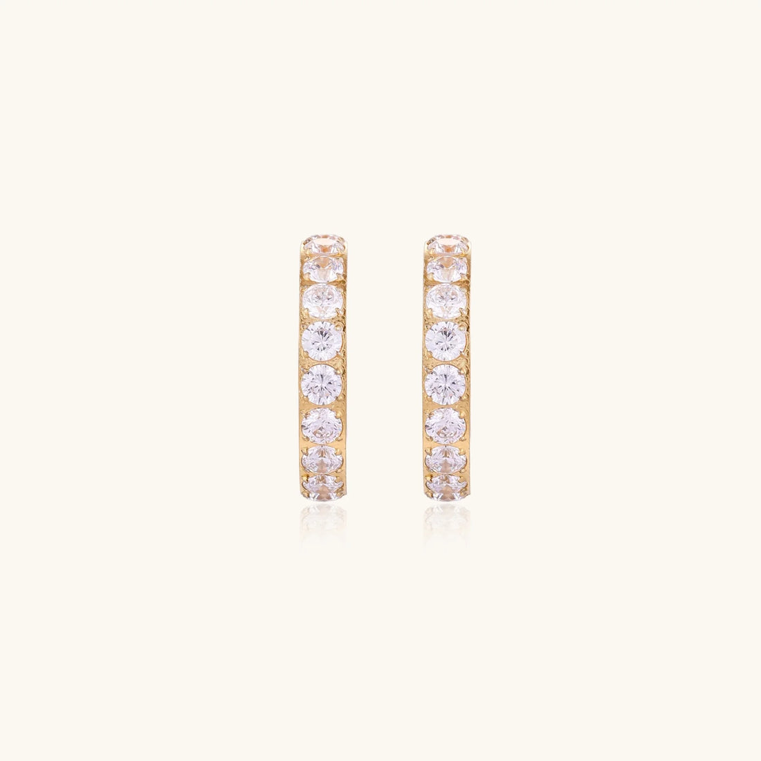 Gold pavé hoop earrings with two freshwater pearls nestled inside the curved design, featuring crystal-studded outer edge.